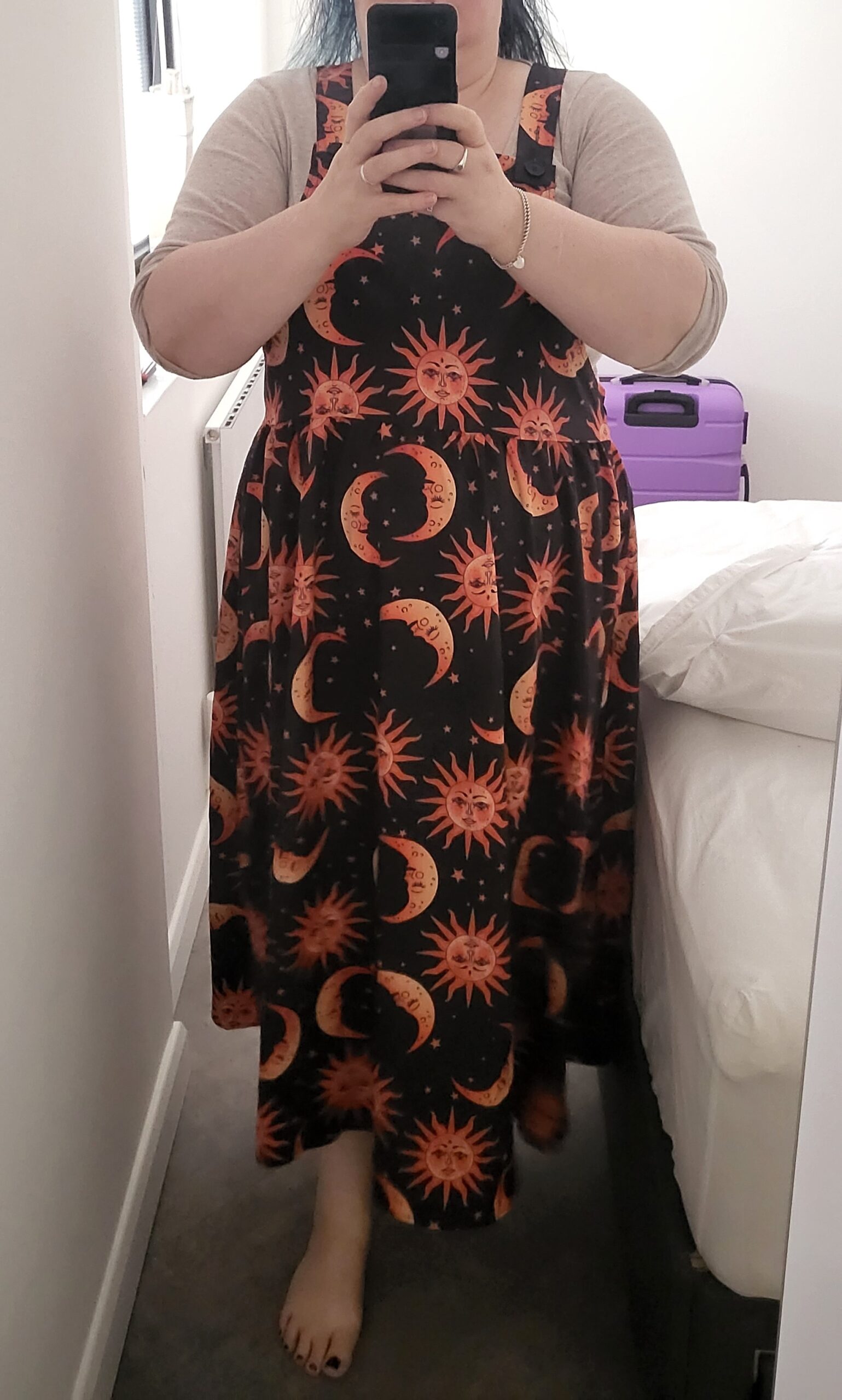 Dungarees with occult images on, skulls, ouija boards, etc, and a picture of a black dress with bright orange suns, moons, and stars on it.